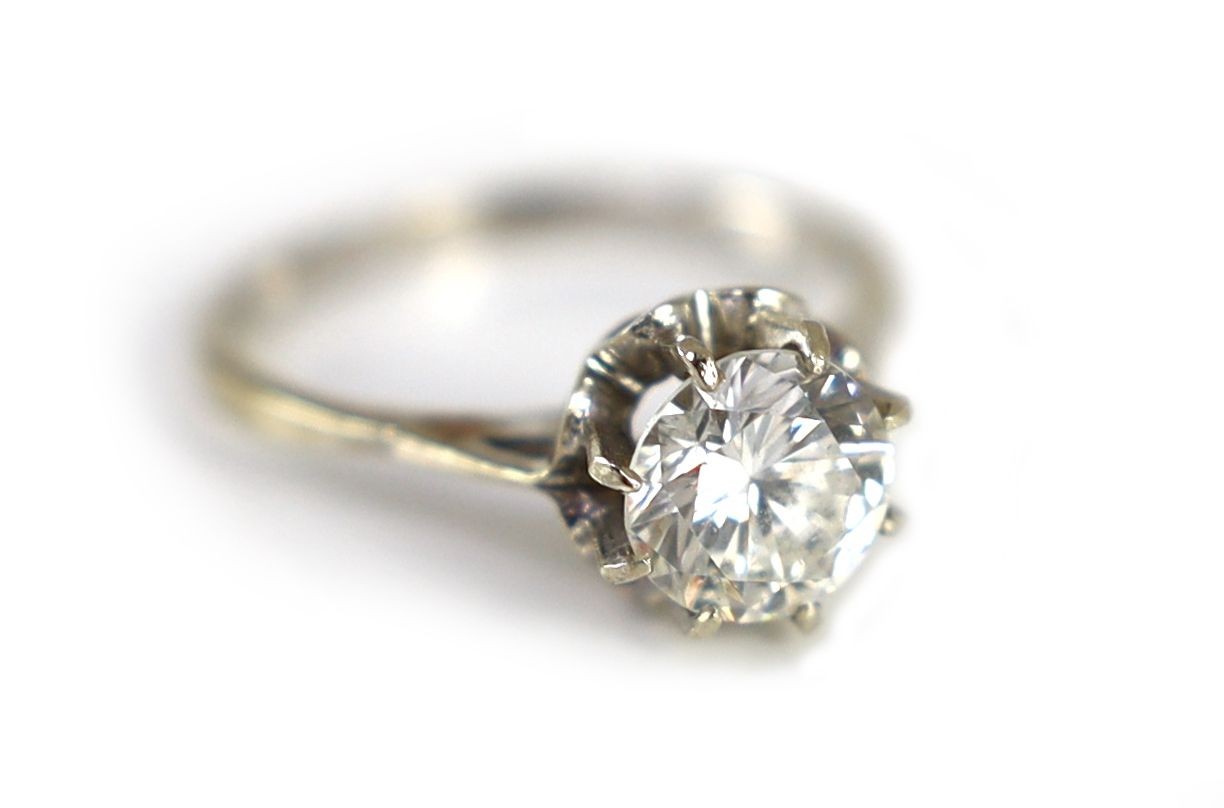 A Continental white gold and solitaire diamond set ring